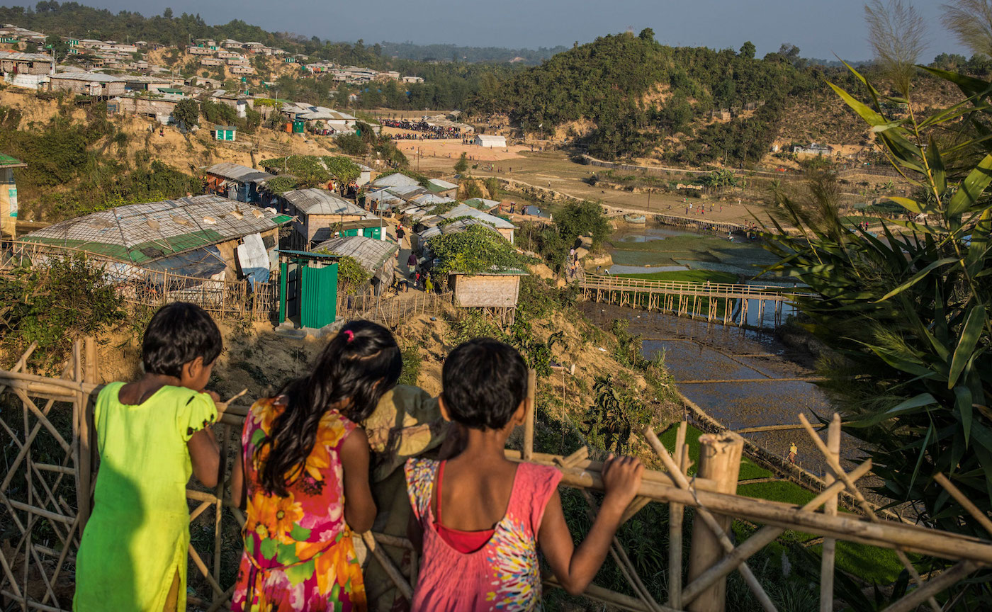 Three Rohingya children overlooking the Cox's Bazar settlement, Bangladesh